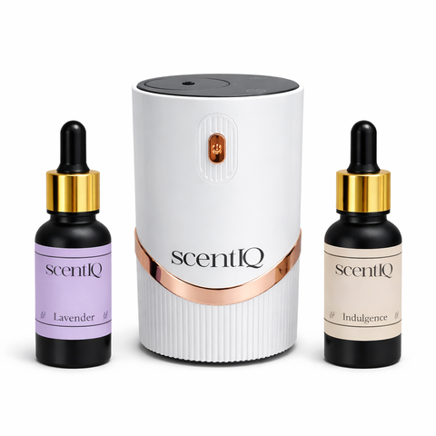 scentIQ waterless diffuser in clean white finish with essential oil bottles on a white background.