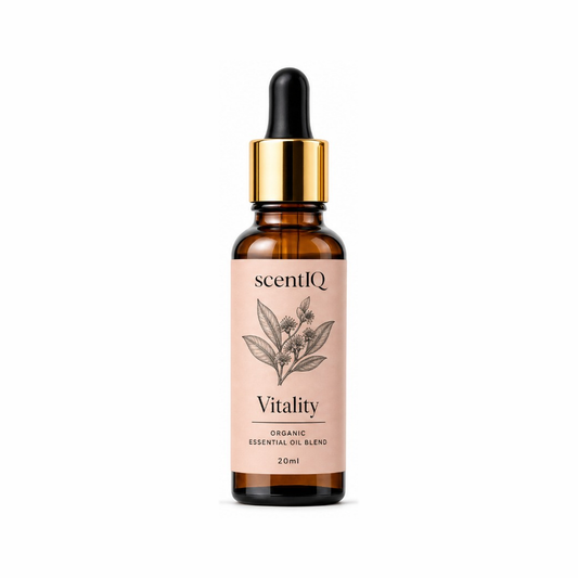 A 20ml amber glass dropper bottle of scentiQ Vitality Organic Essential Oil Blend, featuring a light pink label with a botanical illustration and a shiny gold collar with a black dropper cap, set against a plain white background.